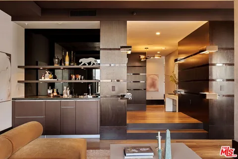 a kitchen with stainless steel appliances kitchen island granite countertop a refrigerator a stove and a microwave oven