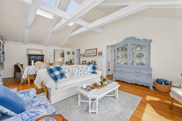 a living room with furniture and painting on the wall