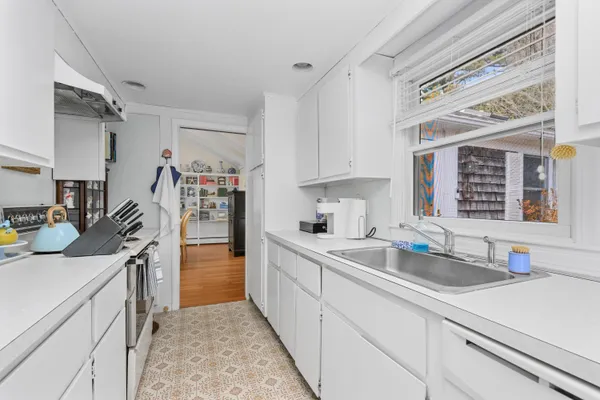 a kitchen with a sink stove and cabinets