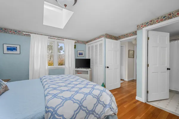 a bedroom with a bed and a dresser
