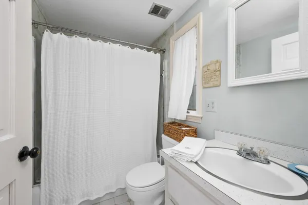 a white toilet sitting next to a bathroom sink
