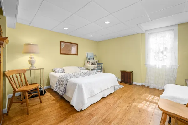 a spacious bedroom with a bed and a window
