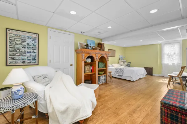 a bedroom with furniture and a large window