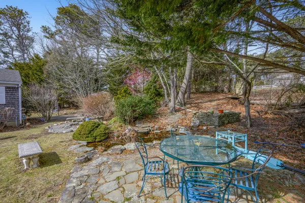 a backyard of a house with table and chairs