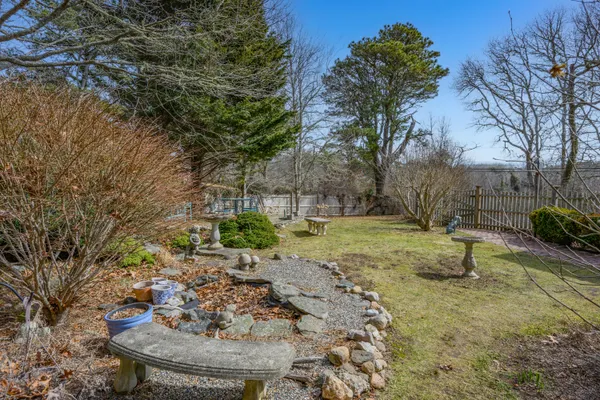 a view of a fire pit with large trees