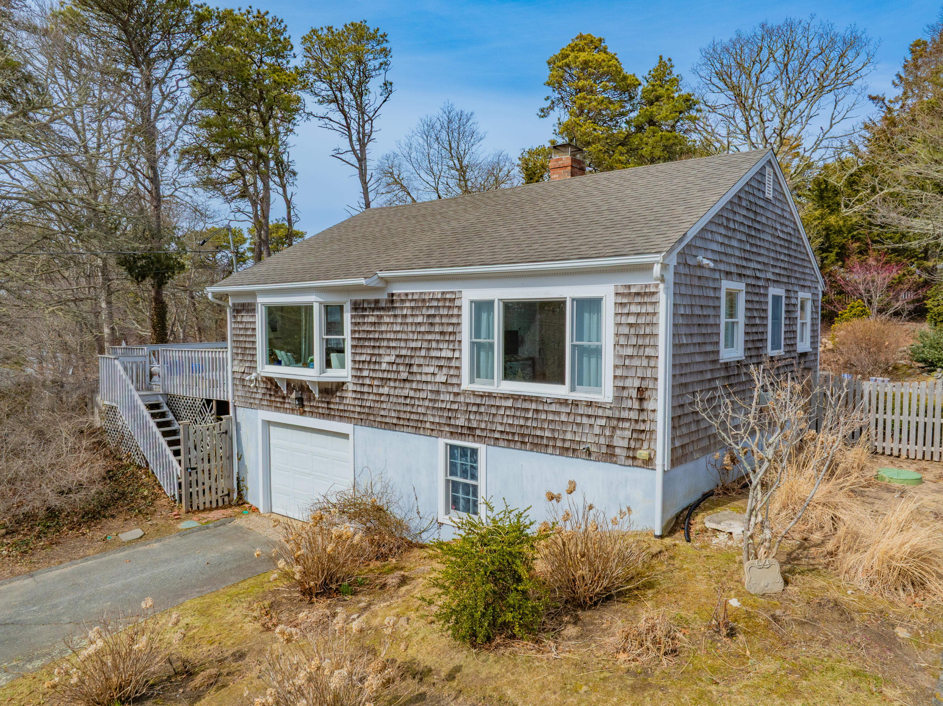 118 Wilfred Road Chatham, MA 02633 - Photo 43 of 49 a front view of a house with a yard and garage