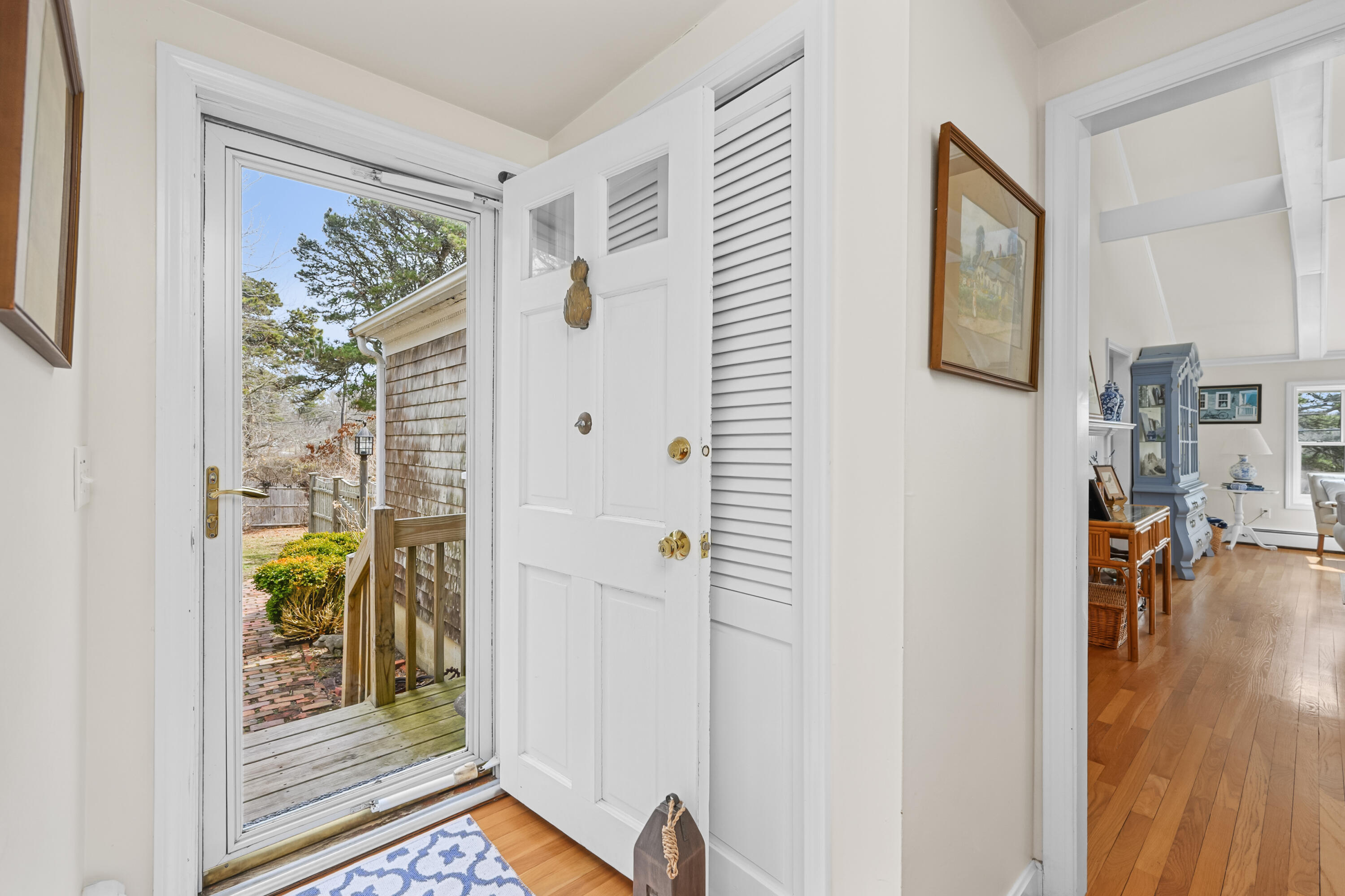 118 Wilfred Road Chatham, MA 02633 - Photo 6 of 49 a view of a hallway with bathroom and wooden floor