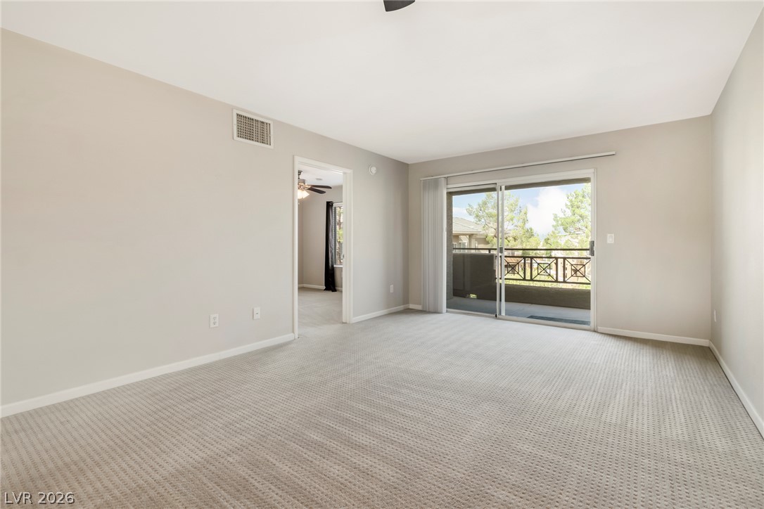 8070 West Russell Road, Unit 2006 Las Vegas, NV 89113 - Photo 12 of 24 A spacious living area with abundant natural light and balcony access.