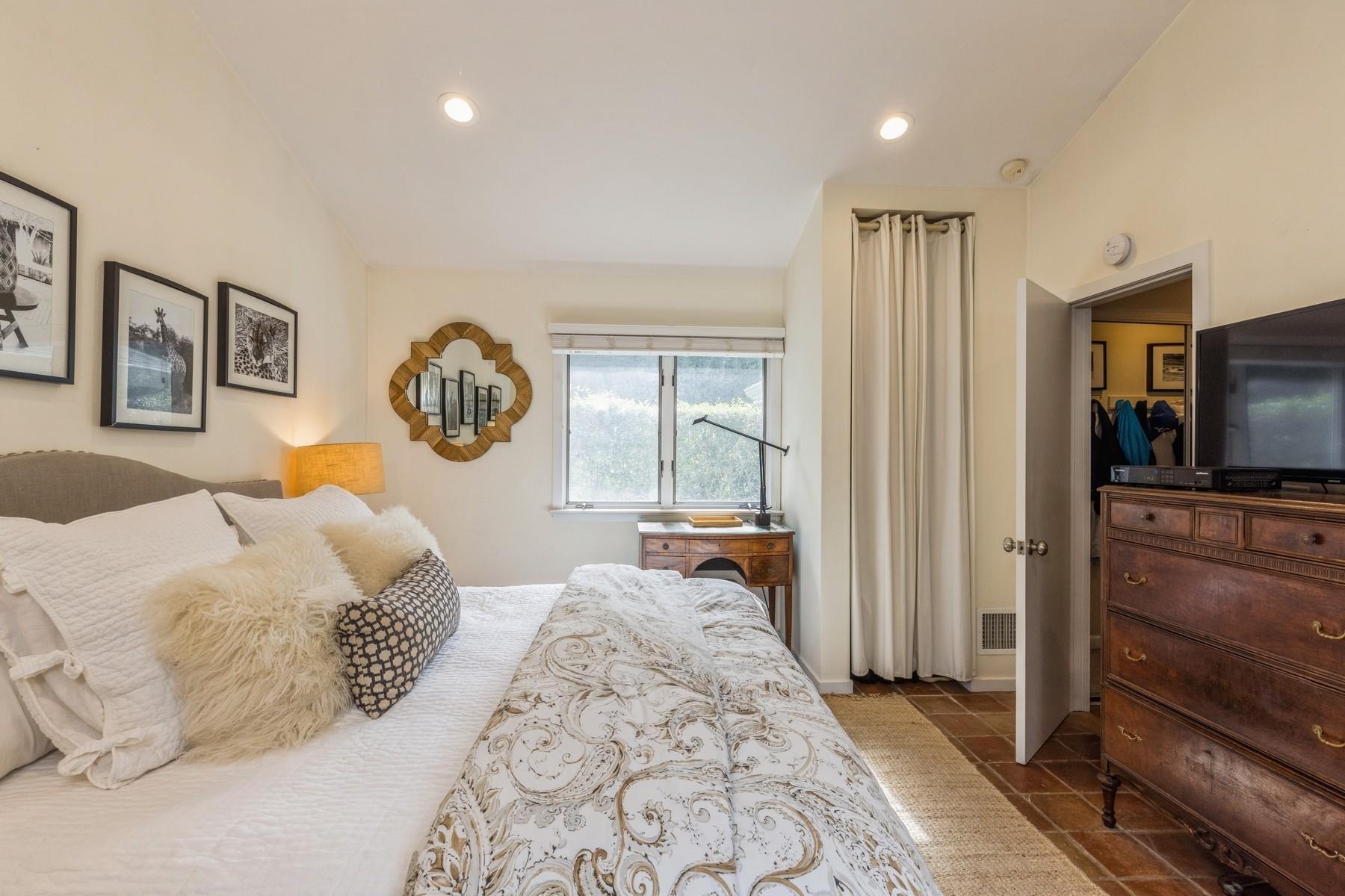 21 Hillover Road East Hampton Bays, NY 11946 - Photo 11 of 33 a bedroom with a bed and a television