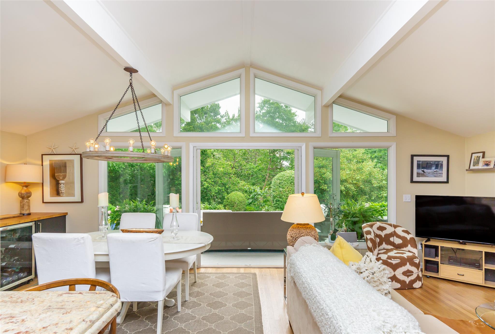 21 Hillover Road East Hampton Bays, NY 11946 - Photo 16 of 33 a living room with furniture a flat screen tv and a large window