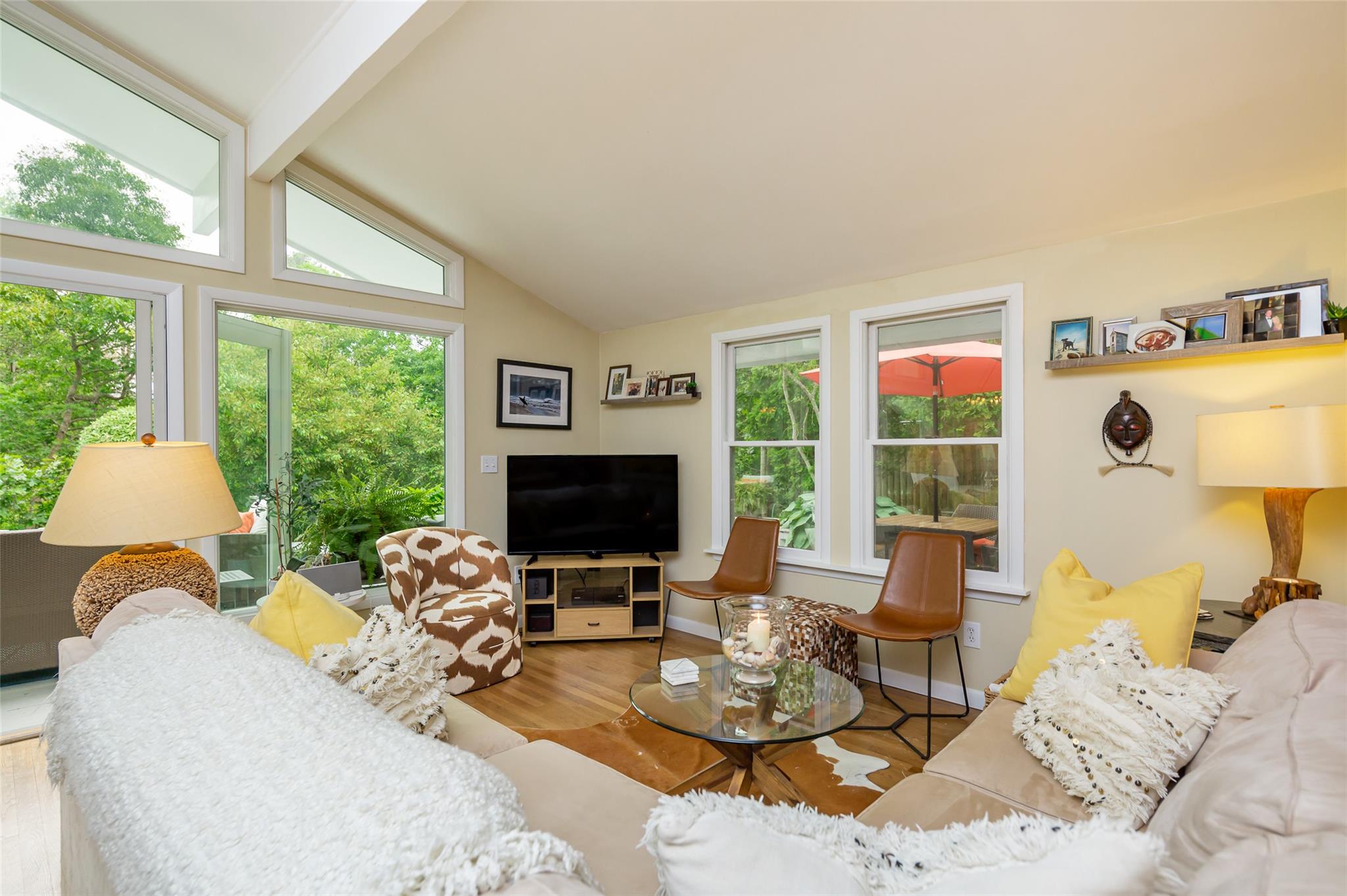 21 Hillover Road East Hampton Bays, NY 11946 - Photo 17 of 33 a living room with furniture a fireplace and a flat screen tv