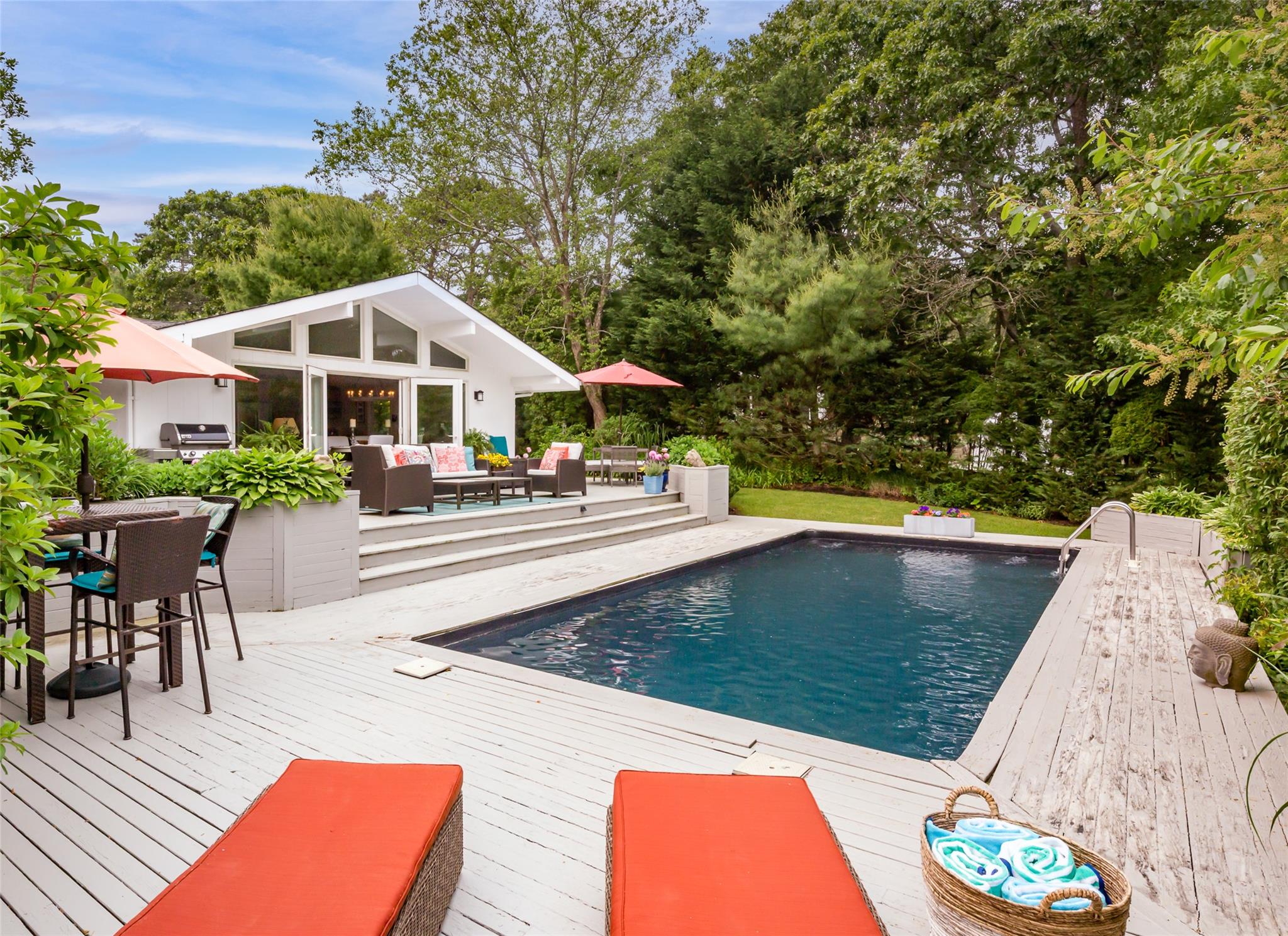 21 Hillover Road East Hampton Bays, NY 11946 - Photo 24 of 33 a view of a chairs and table in the patio