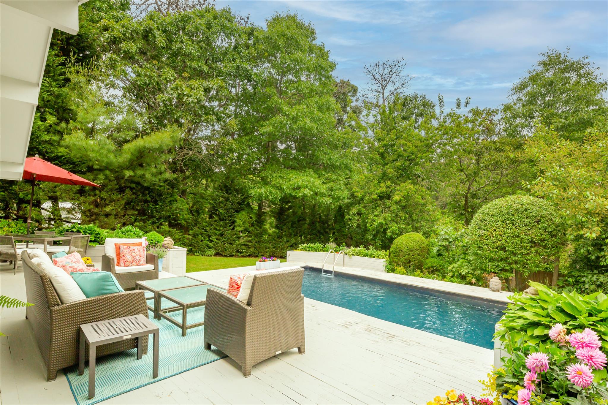21 Hillover Road East Hampton Bays, NY 11946 - Photo 28 of 33 a view of a chairs and table in the backyard