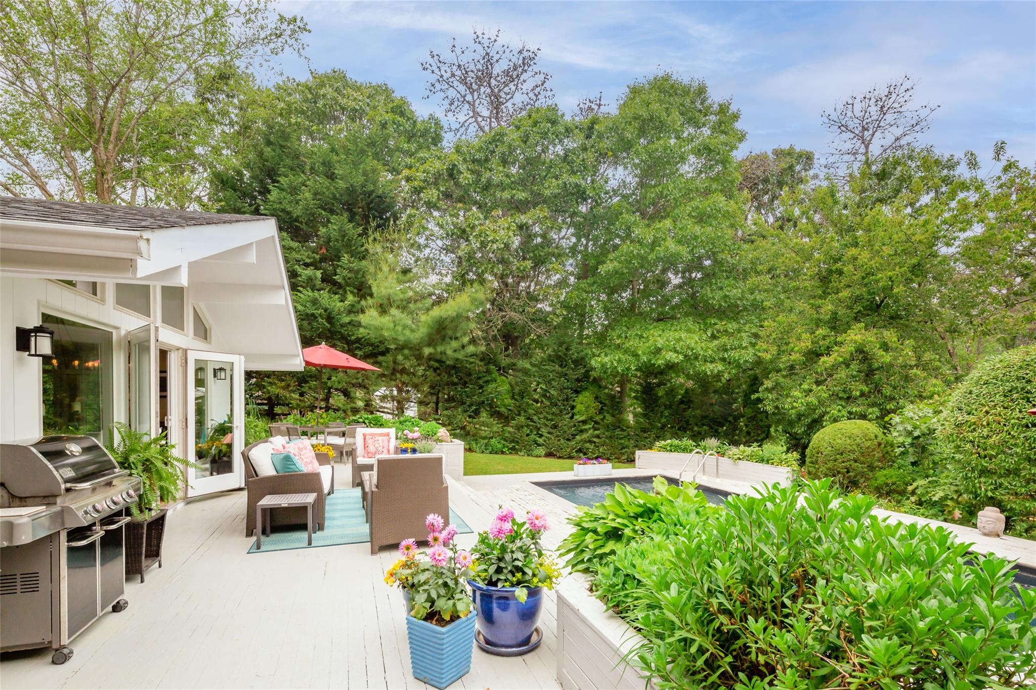 21 Hillover Road East Hampton Bays, NY 11946 - Photo 29 of 33 a view of a patio with table and chairs potted plants