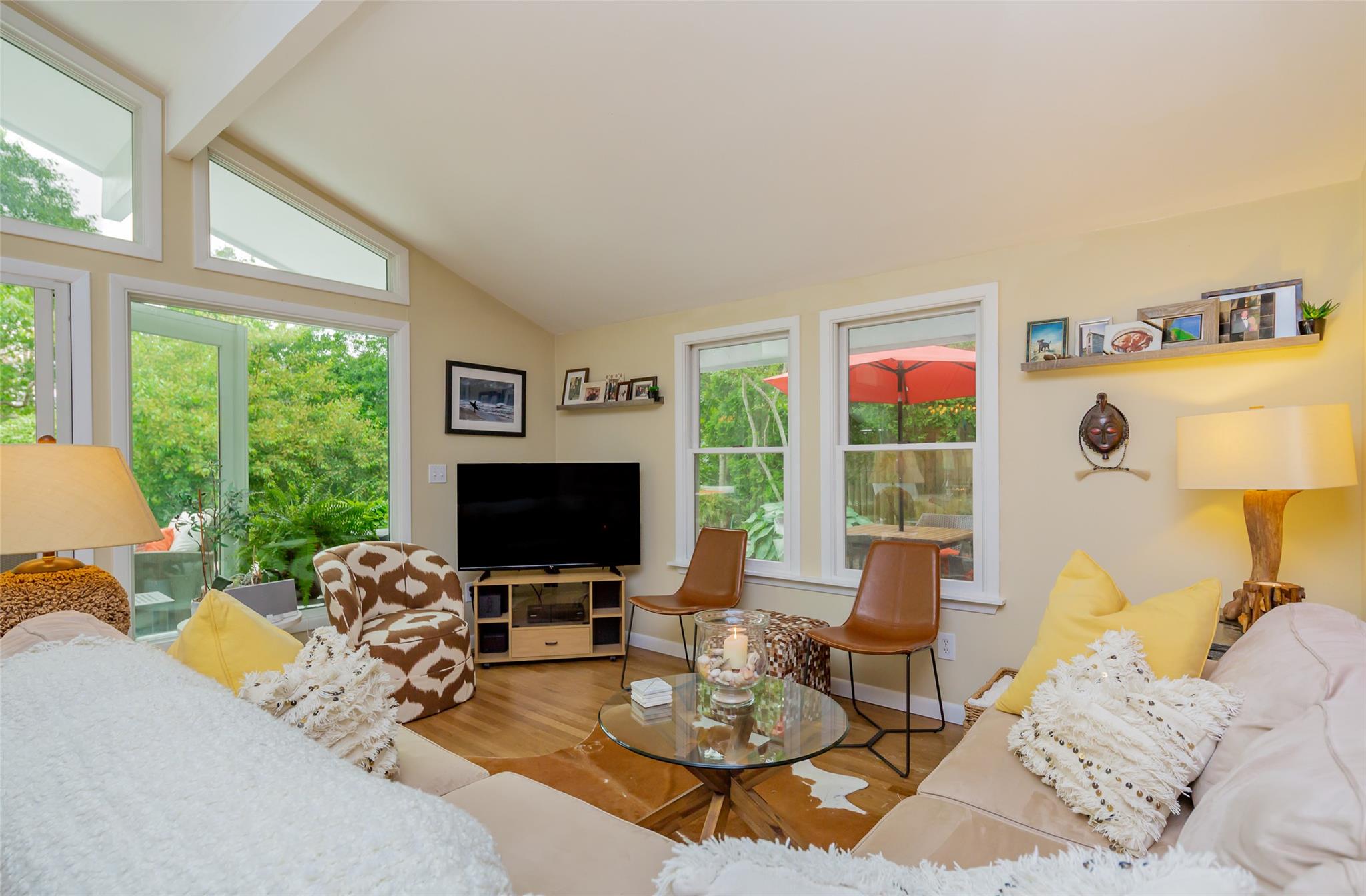 21 Hillover Road East Hampton Bays, NY 11946 - Photo 31 of 33 a living room with furniture a flat screen tv and a floor to ceiling window