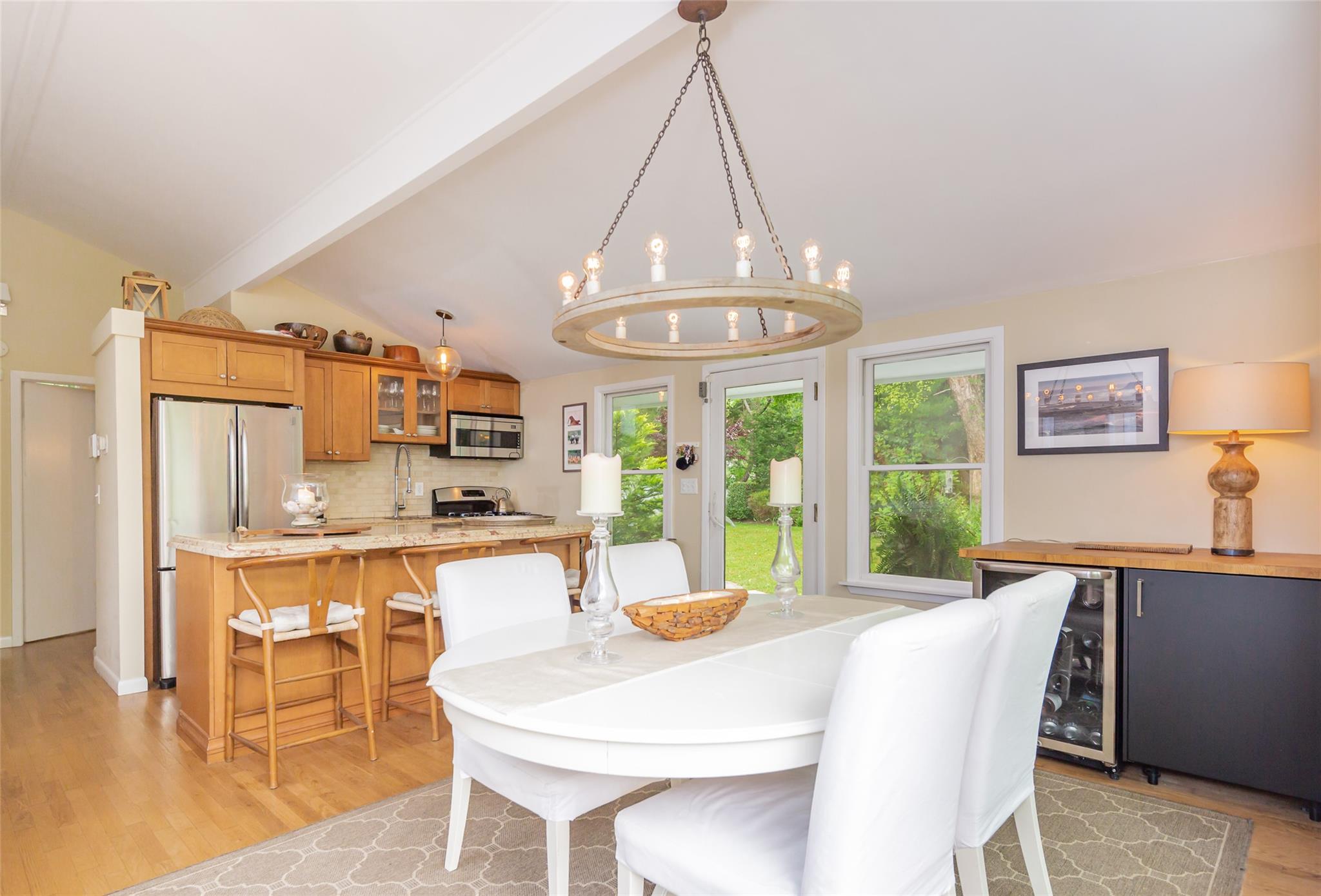 21 Hillover Road East Hampton Bays, NY 11946 - Photo 33 of 33 a view of a dining room with furniture a chandelier and wooden floor