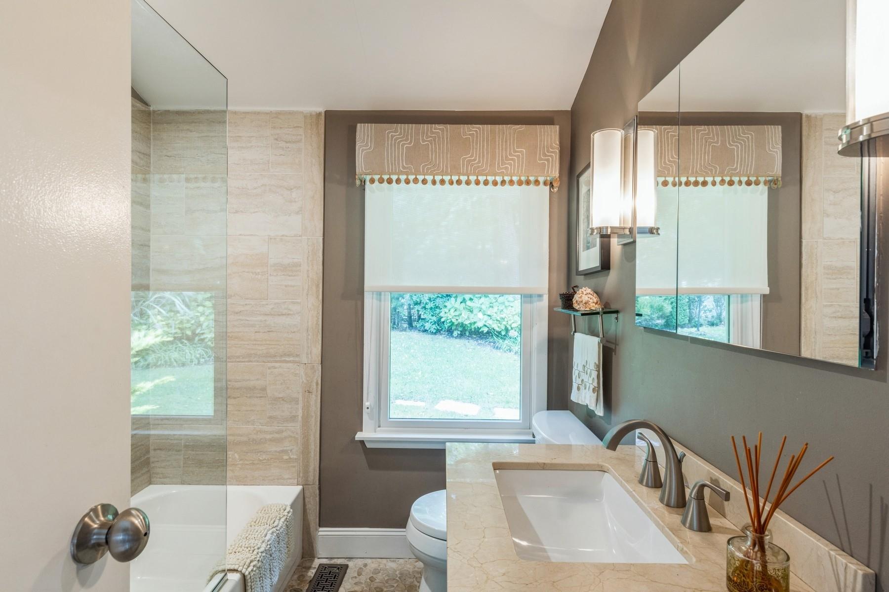 21 Hillover Road East Hampton Bays, NY 11946 - Photo 8 of 33 a bathroom with a sink mirror and a bathtub