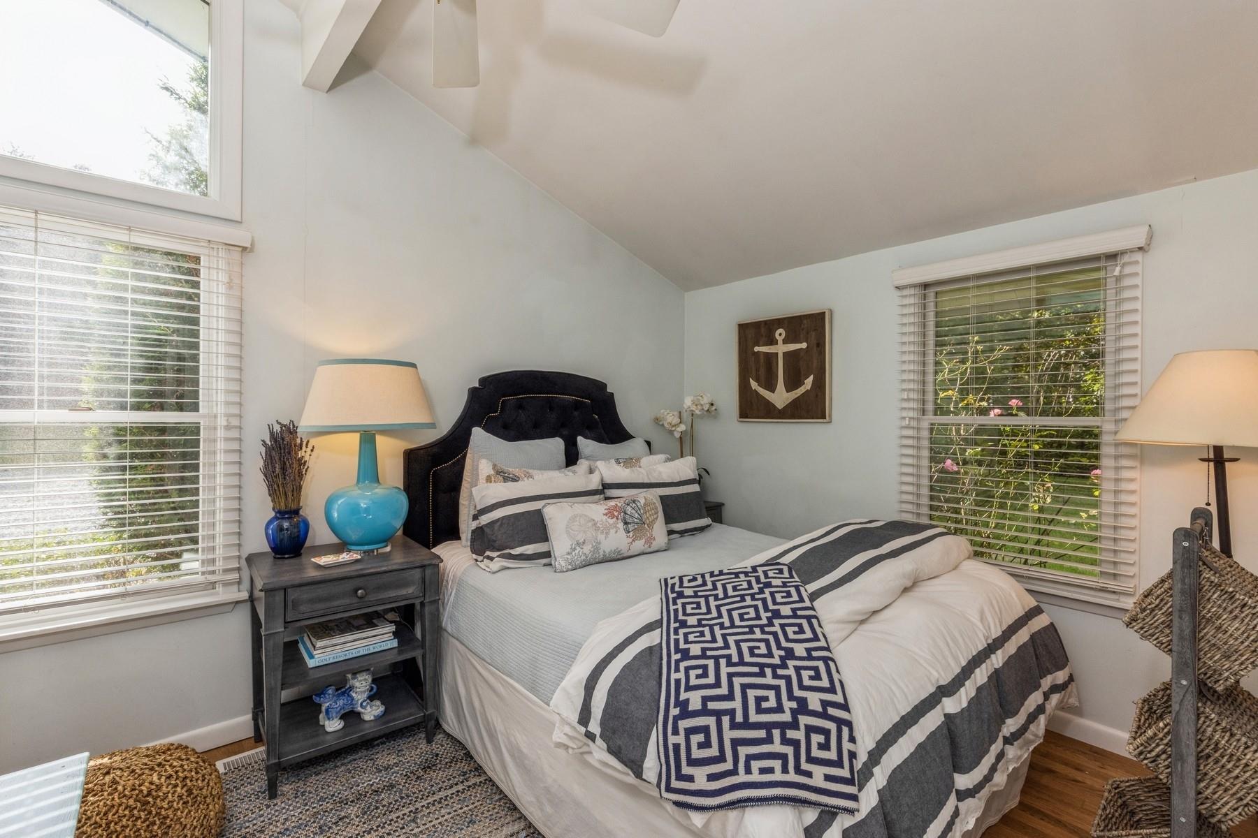21 Hillover Road East Hampton Bays, NY 11946 - Photo 9 of 33 a bedroom with a bed and a window