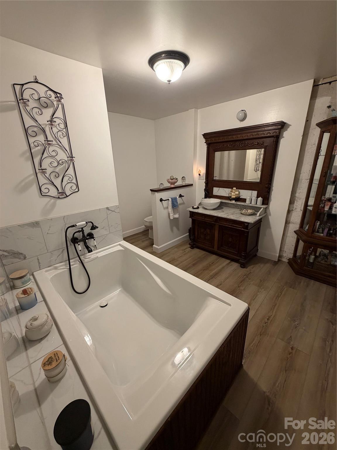 658 Upper Hanging Rock Road Spruce Pine, NC 28777 - Photo 12 of 35 a bathroom with a tub sink and mirror