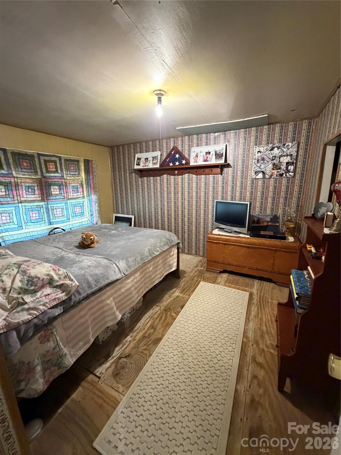 658 Upper Hanging Rock Road Spruce Pine, NC 28777 - Photo 18 of 35 a bedroom with double bed and a window