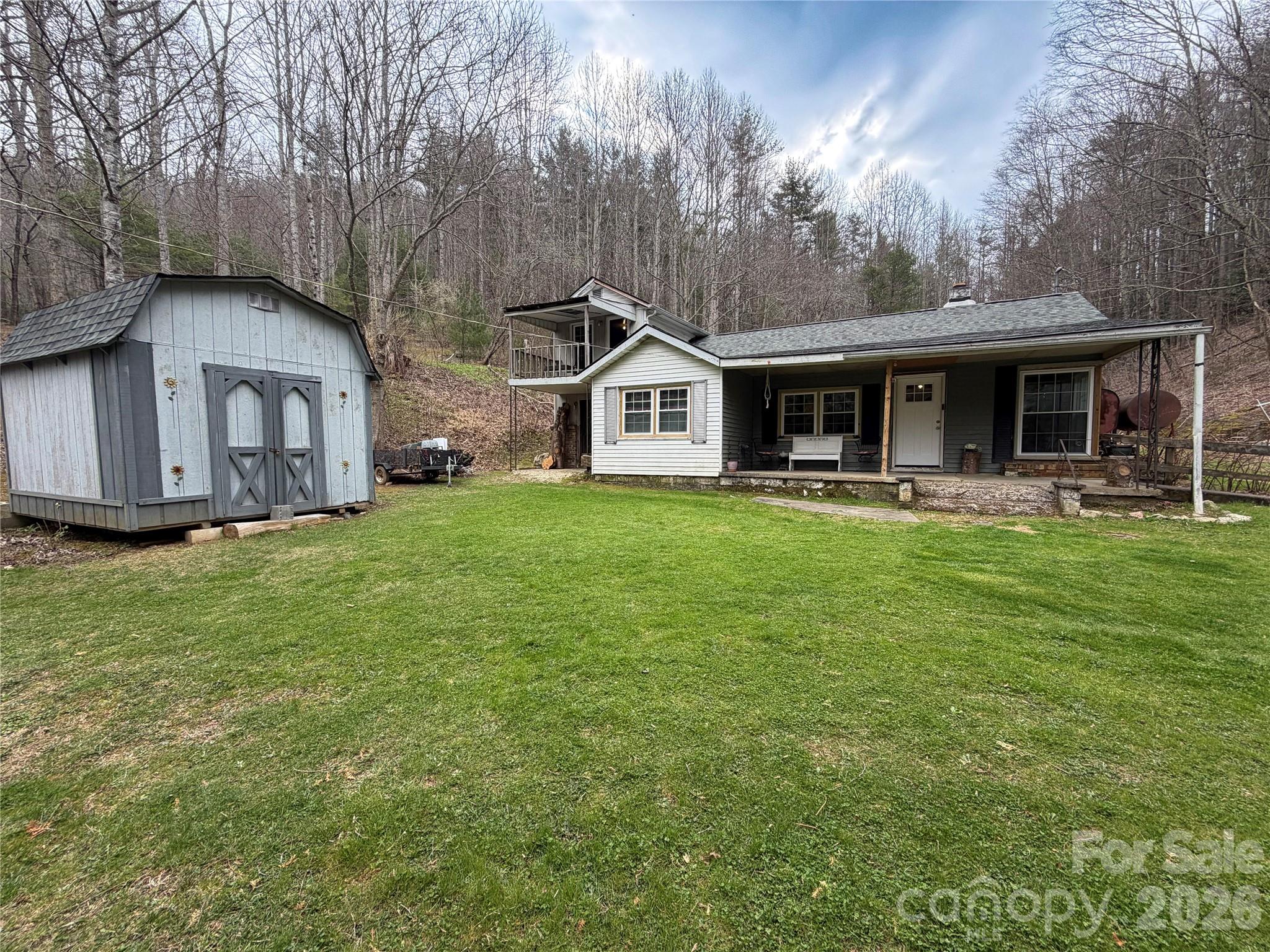 658 Upper Hanging Rock Road Spruce Pine, NC 28777 - Photo 2 of 35 a front view of house with yard and trees in the background