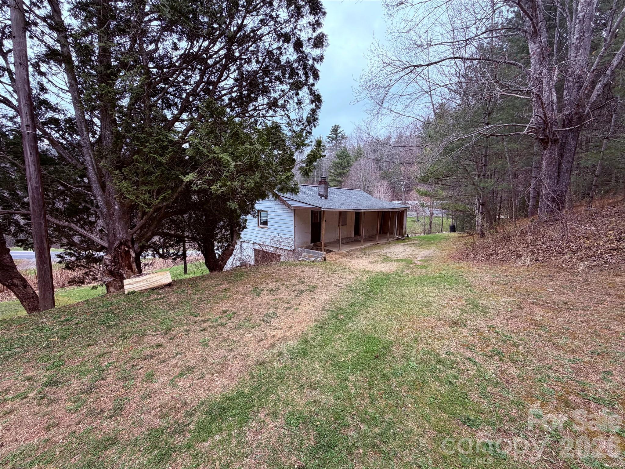658 Upper Hanging Rock Road Spruce Pine, NC 28777 - Photo 25 of 35 a view of a house with a yard