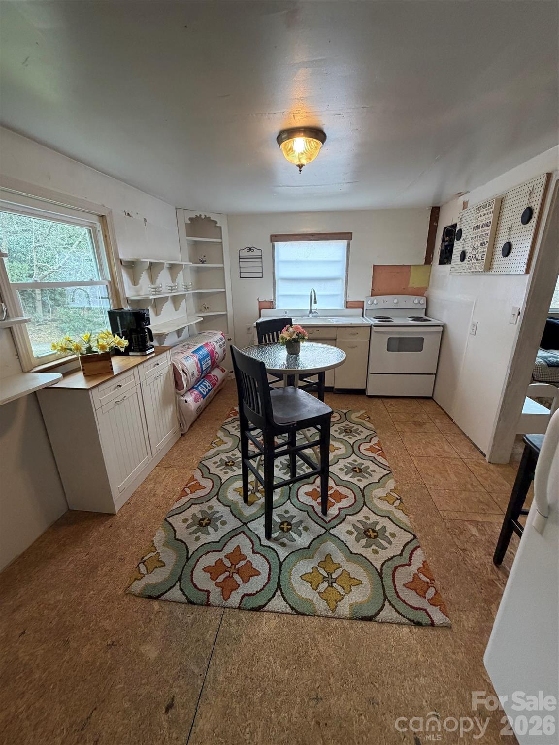 658 Upper Hanging Rock Road Spruce Pine, NC 28777 - Photo 26 of 35 a living room with furniture a fireplace and a large window