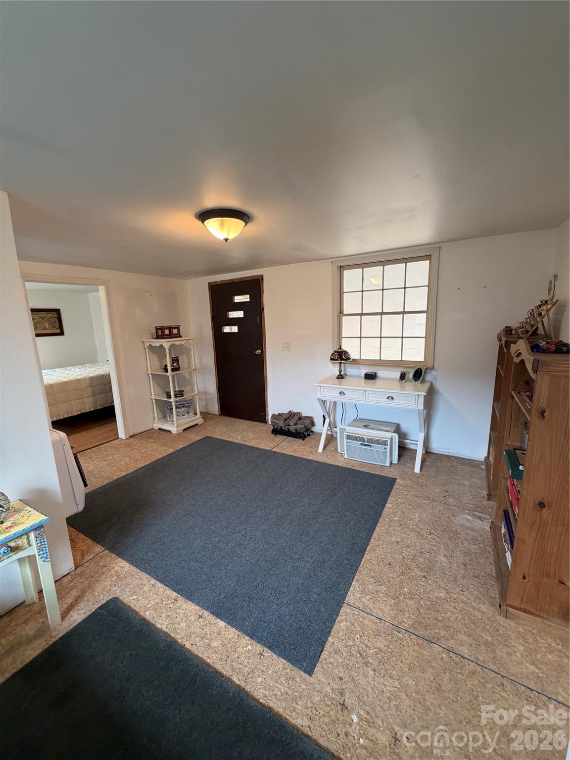 658 Upper Hanging Rock Road Spruce Pine, NC 28777 - Photo 29 of 35 a living room with furniture and a window