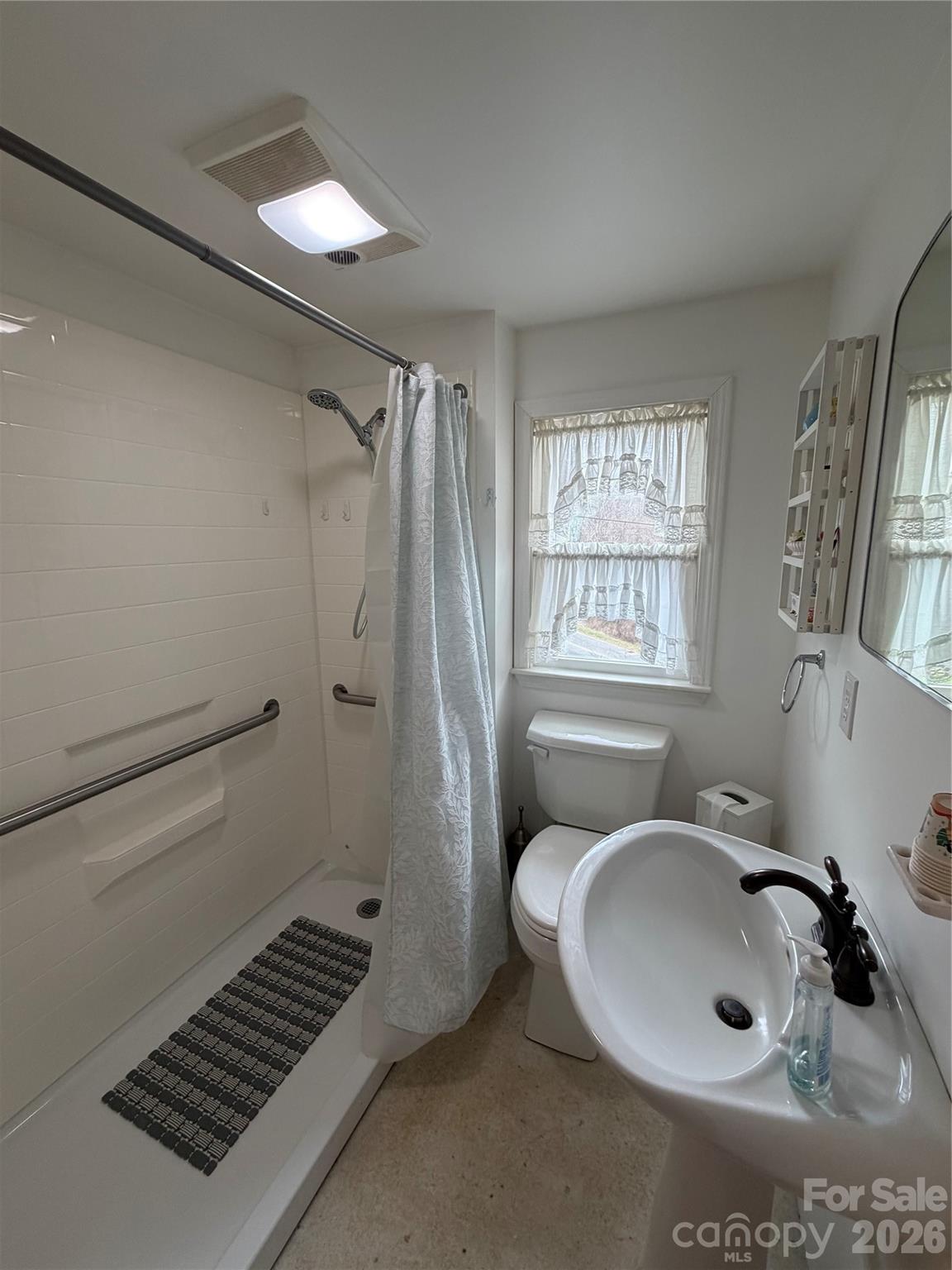 658 Upper Hanging Rock Road Spruce Pine, NC 28777 - Photo 30 of 35 a bathroom with a sink toilet and shower