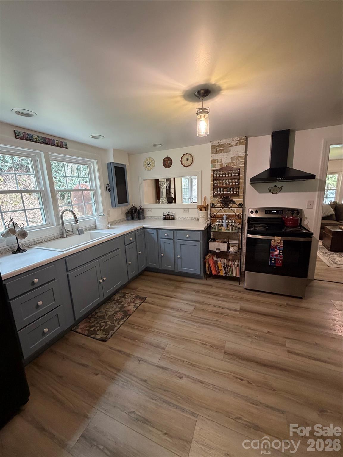 658 Upper Hanging Rock Road Spruce Pine, NC 28777 - Photo 6 of 35 a large kitchen with stainless steel appliances granite countertop a oven and a sink with cabinets