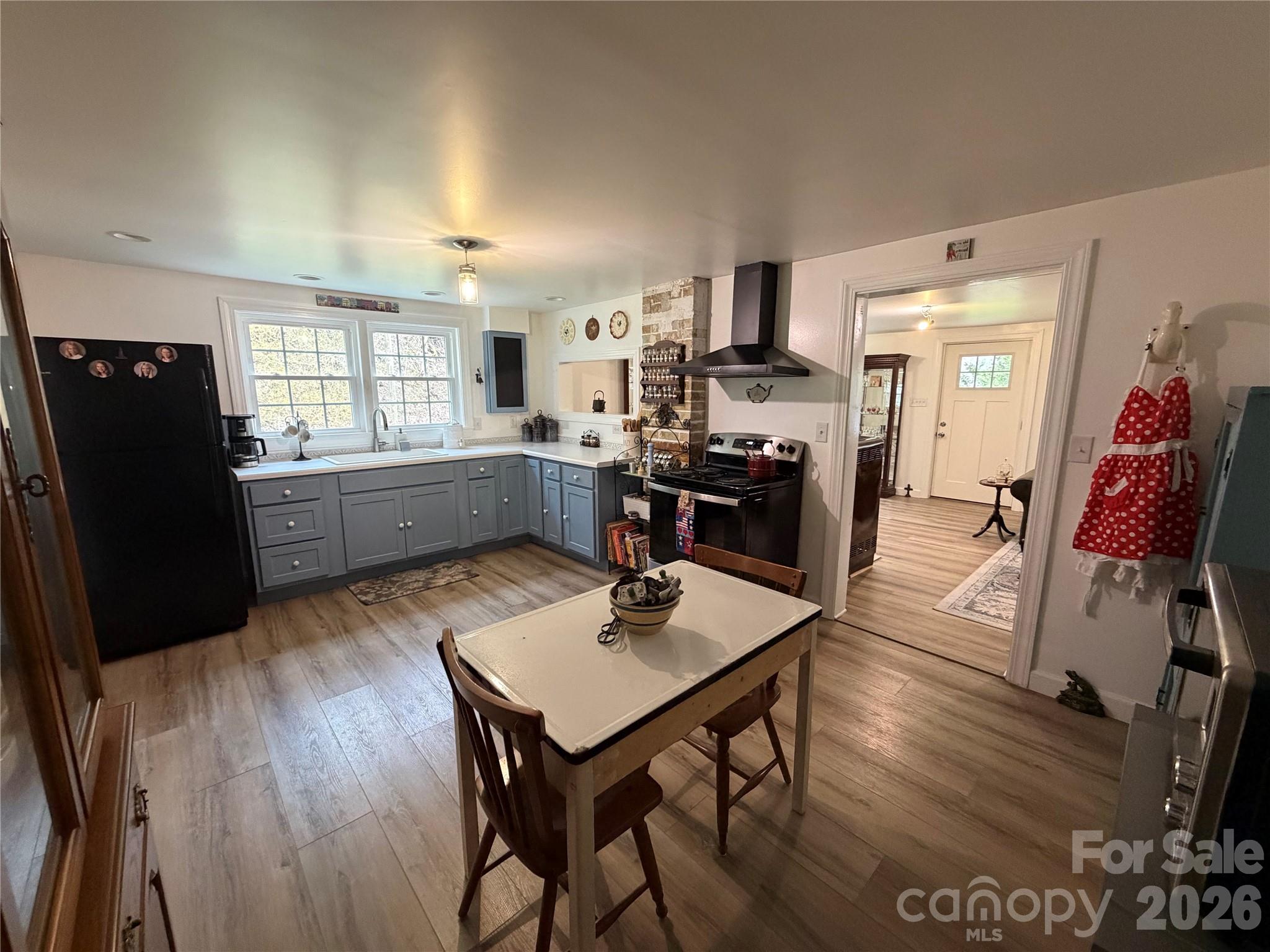 658 Upper Hanging Rock Road Spruce Pine, NC 28777 - Photo 9 of 35 a kitchen with a table chairs refrigerator and microwave