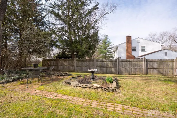 a view of a dining room with furniture a chandelier and wooden floor