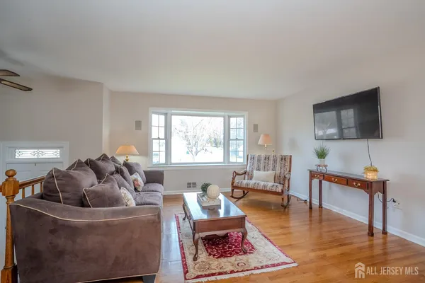 a living room with furniture rug and window
