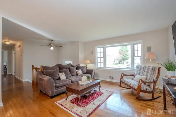 a view of staircase with lots of frames on wall and a window