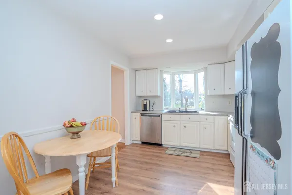 a kitchen with a refrigerator sink and cabinets
