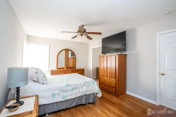 a bedroom with a large bed and a chandelier