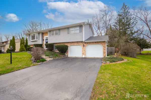 a view of a house with a yard and garage