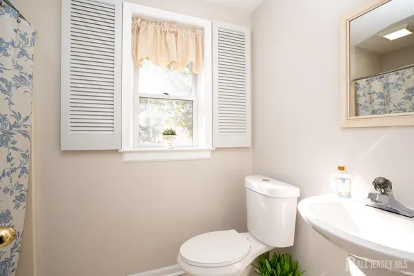 a view of a bathroom with a shower curtain