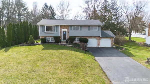 an aerial view of residential houses with outdoor space and swimming pool