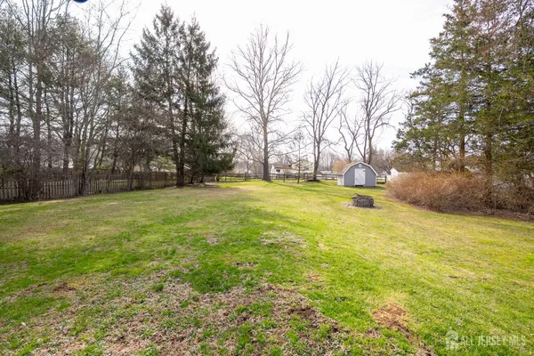 a swimming pool with trees in the background