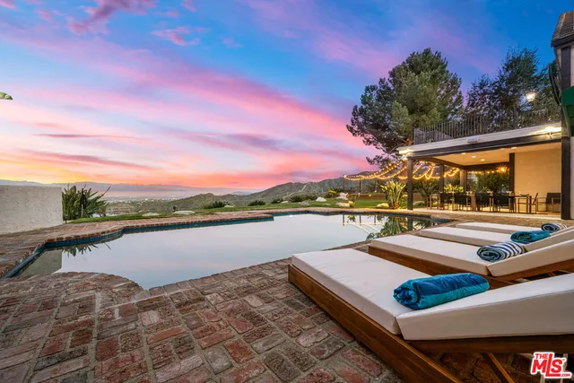 a view of a lake with couches and city view