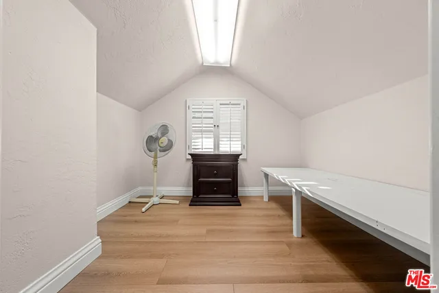 a bathroom with a toilet sink a mirror a shower and vanity