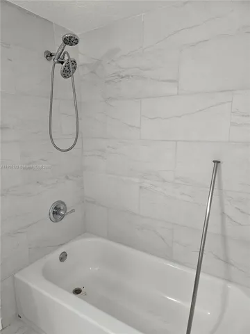 a bathroom with a bath tub and a shower