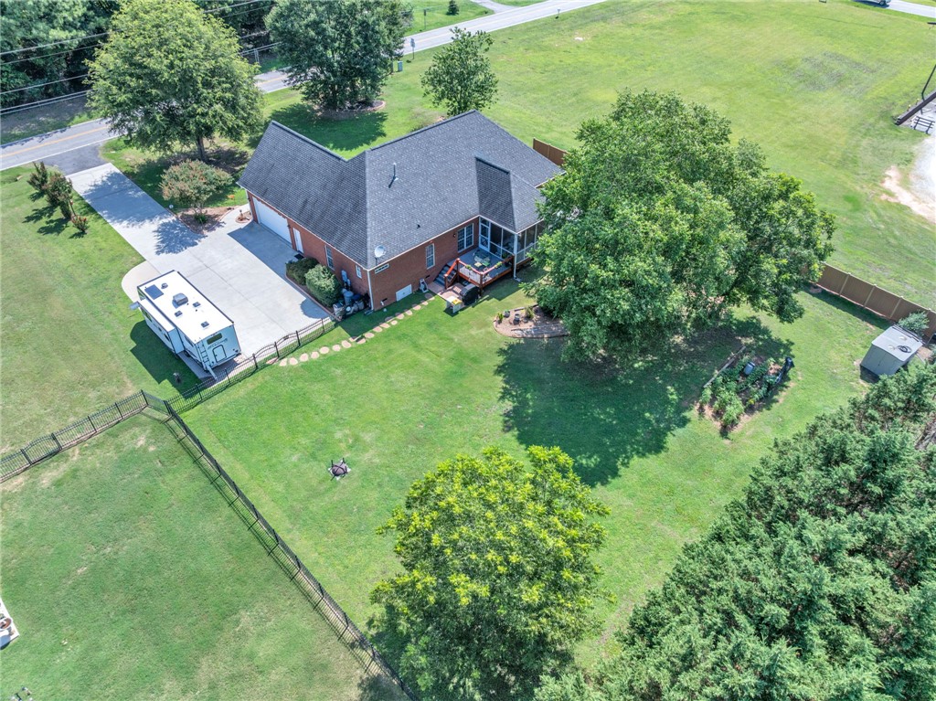 648 Mountain View Road Williamston, SC 29697 - Photo 37 of 42 An aerial view showcases a verdant fenced yard leading to a spacious driveway.