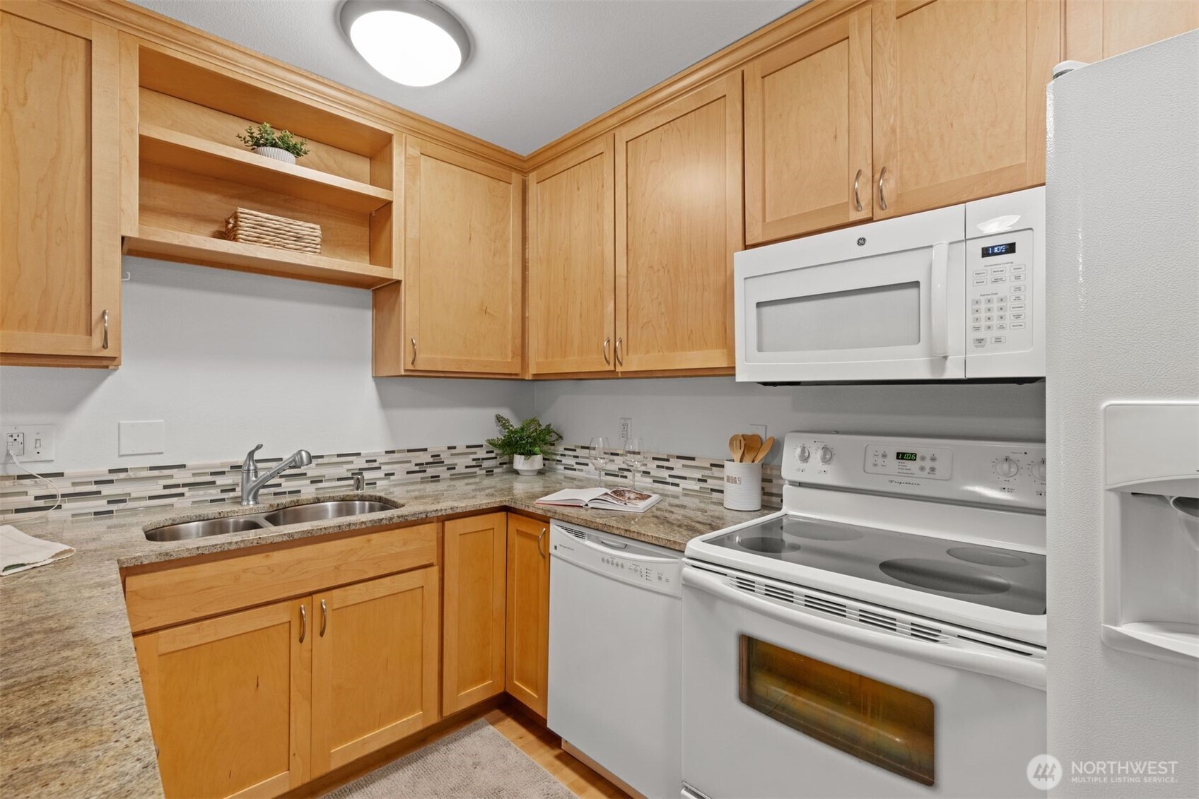 6423 Sand Point Way Northeast Seattle, WA 98115 - Photo 14 of 40 a kitchen with stainless steel appliances white cabinets and a stove top oven