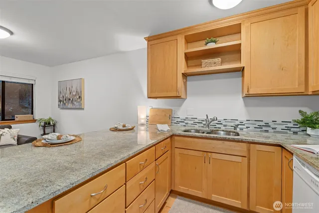 a kitchen with stainless steel appliances granite countertop a sink and cabinets