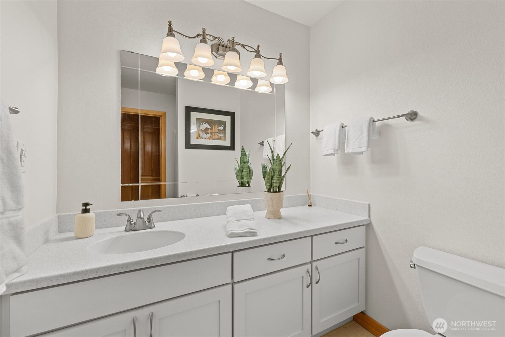 6423 Sand Point Way Northeast Seattle, WA 98115 - Photo 22 of 40 a bathroom with a sink a large mirror and vanity