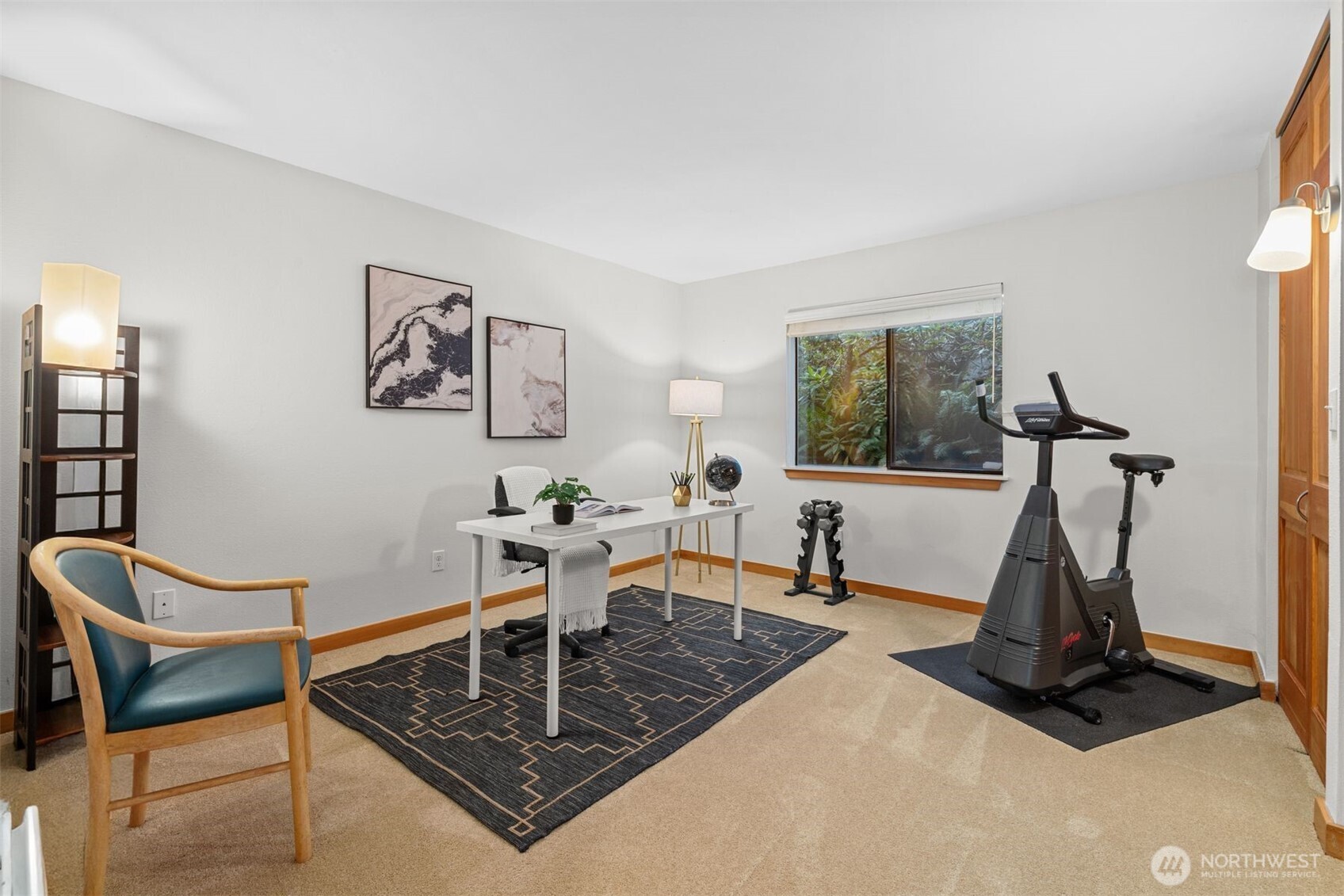 6423 Sand Point Way Northeast Seattle, WA 98115 - Photo 24 of 40 a living room with furniture a window and gym cycle