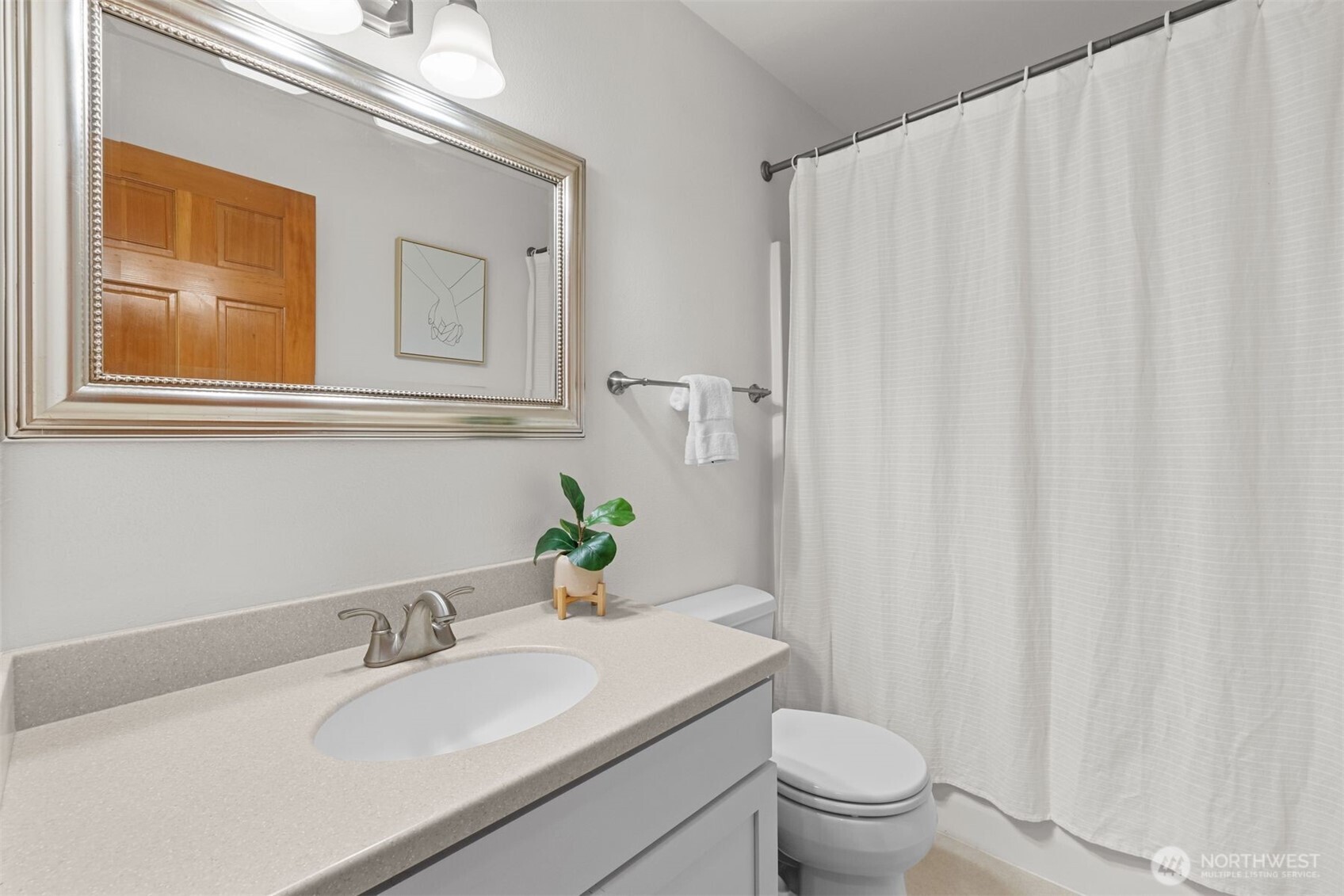 6423 Sand Point Way Northeast Seattle, WA 98115 - Photo 25 of 40 a bathroom with a granite countertop sink and a toilet