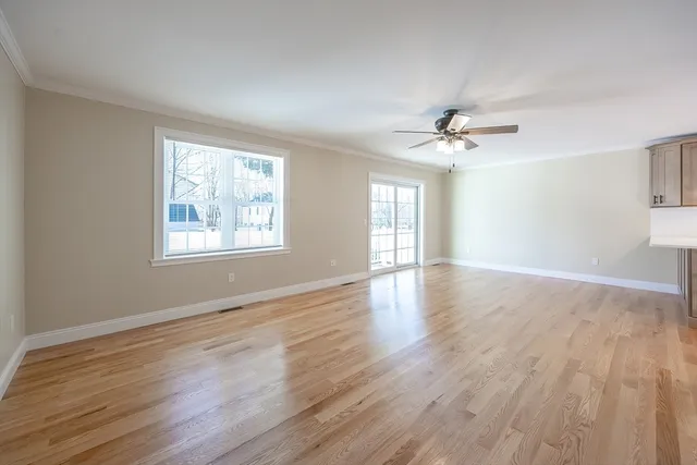 a view of an empty room and wooden floor